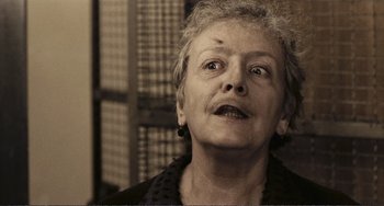 Movie still from “A Special Day” (1977), directed by Ettore Scola – An older woman looking up at the camera; Close Up shot, Low angle