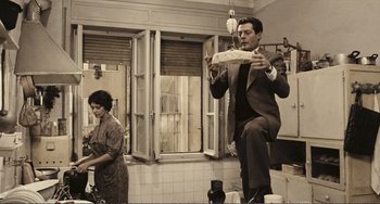 Movie still from “A Special Day” (1977), directed by Ettore Scola – A man and a woman are in a kitchen; Wide shot, Low angle