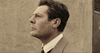 Movie still from “A Special Day” (1977), directed by Ettore Scola – A person wearing a suit and tie; Close Up shot, Low angle