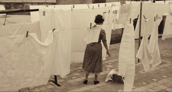 Movie still from “A Special Day” (1977), directed by Ettore Scola – An old woman hanging clothes on a clothesline; Wide shot, High angle