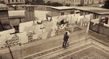 Movie still from “A Special Day” (1977), directed by Ettore Scola – A man and a woman standing next to each other; Extreme Wide shot, Overhead angle