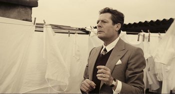 Movie still from “A Special Day” (1977), directed by Ettore Scola – A black and white photo of a man in a suit and tie; Medium shot, Low angle