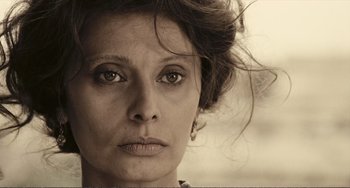 Movie still from “A Special Day” (1977), directed by Ettore Scola – An old photo of a woman with big brown eyes; Close Up shot, Low angle