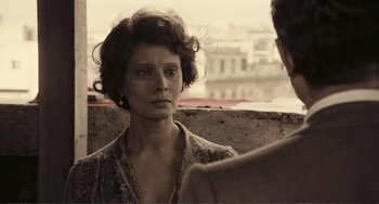 Movie still from “A Special Day” (1977), directed by Ettore Scola – A woman looking at another woman in a black and white photo; Close Up shot, Over the shoulder angle
