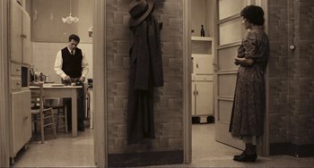 Movie still from “A Special Day” (1977), directed by Ettore Scola – Two people in a room with a brick wall; Wide shot, High angle