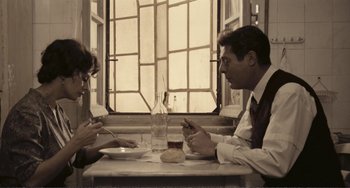 Movie still from “A Special Day” (1977), directed by Ettore Scola – A man and a woman sitting at a dinner table; Medium shot, High angle