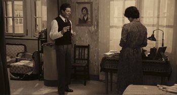 Movie still from “A Special Day” (1977), directed by Ettore Scola – A man and a woman standing in front of a window; Wide shot, High angle