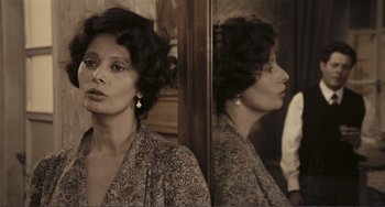Movie still from “A Special Day” (1977), directed by Ettore Scola – A woman is standing in front of a mirror; Close Up shot, Over the shoulder angle