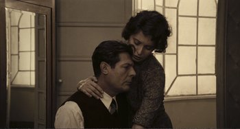 Movie still from “A Special Day” (1977), directed by Ettore Scola – An older man and a younger woman in a room; Medium shot, High angle