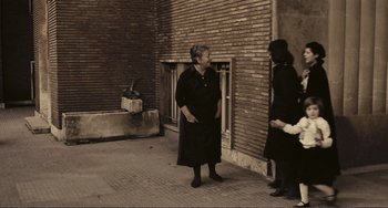 Movie still from “A Special Day” (1977), directed by Ettore Scola – Two women are standing outside talking to each other; Wide shot, High angle