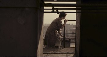 Movie still from “A Special Day” (1977), directed by Ettore Scola – A woman standing on a balcony looking out at the city; Wide shot, Low angle