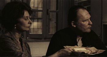Movie still from “A Special Day” (1977), directed by Ettore Scola – A man and a woman sitting at a dinner table; Medium shot, High angle