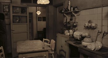 Movie still from “A Special Day” (1977), directed by Ettore Scola – An old fashioned kitchen with a table and chairs; Wide shot, High angle