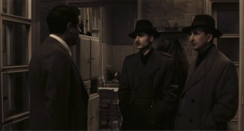 Movie still from “A Special Day” (1977), directed by Ettore Scola – A man in a suit and hat talking to another man in a suit and hat; Medium shot, Over the shoulder angle