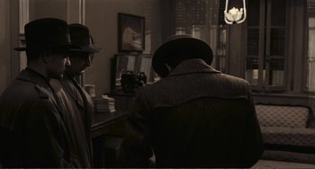 Movie still from “A Special Day” (1977), directed by Ettore Scola – A man and a woman wearing hats and coats in a room; Medium shot, High angle