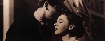 Movie still from “A Star Is Born” (1954), directed by George Cukor – A man and a woman face to face in a black and white photo; Close Up shot, Low angle