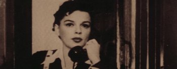 Movie still from “A Star Is Born” (1954), directed by George Cukor – An old black and white photo of a woman talking on a phone; Close Up shot, High angle