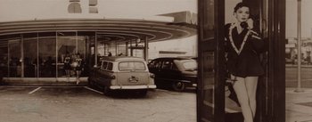 Movie still from “A Star Is Born” (1954), directed by George Cukor – An old photo of two cars parked at a gas station; Wide shot, Low angle