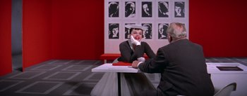 Movie still from “A Star Is Born” (1954), directed by George Cukor – A man and a woman sitting at a table talking to each other; Medium shot, Over the shoulder angle