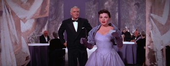 Movie still from “A Star Is Born” (1954), directed by George Cukor – A man and a woman dressed in formal wear; Medium shot, Low angle