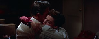 Movie still from “A Star Is Born” (1954), directed by George Cukor – A man and a woman hugging each other in a dark room; Close Up shot, High angle