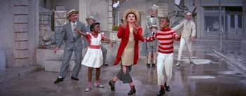 Movie still from “A Star Is Born” (1954), directed by George Cukor – A group of young people dancing in the street; Wide shot, High angle