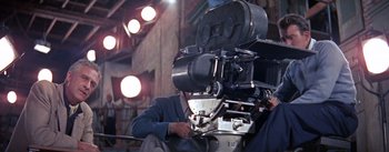 Movie still from “A Star Is Born” (1954), directed by George Cukor – A man sitting in front of an old camera; Medium shot, Low angle