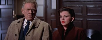 Movie still from “A Star Is Born” (1954), directed by George Cukor – A man and a woman standing next to each other; Close Up shot, Low angle