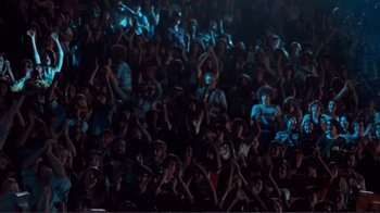 Movie still from “A Star Is Born” (1976), directed by Frank Pierson – A crowd of people sitting and standing in a dark room; Extreme Wide shot, High angle