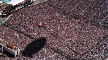 Movie still from “A Star Is Born” (1976), directed by Frank Pierson – An aerial view of a large crowd of people in a stadium; Extreme Wide shot, Overhead angle