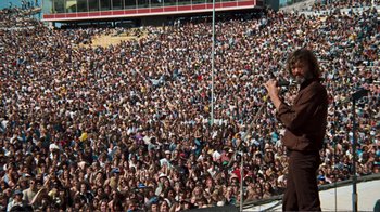 Movie still from “A Star Is Born” (1976), directed by Frank Pierson – A crowd of people sitting in a stadium; Wide shot, High angle
