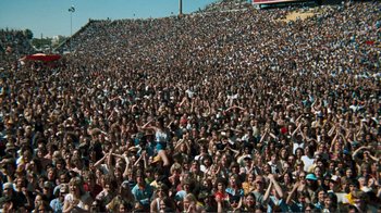 Movie still from “A Star Is Born” (1976), directed by Frank Pierson – A crowd of people sitting in the middle of a stadium; Extreme Wide shot, High angle