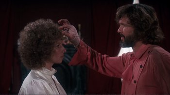 Movie still from “A Star Is Born” (1976), directed by Frank Pierson – A man touching a woman's hair while she looks at the man; Close Up shot, Over the shoulder angle
