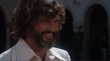 Movie still from “A Star Is Born” (1976), directed by Frank Pierson – A person wearing a suit and smiling; Close Up shot, Low angle