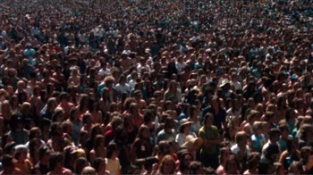 Movie still from “A Star Is Born” (1976), directed by Frank Pierson – A large crowd of people gathered in a large crowd; Extreme Wide shot, High angle
