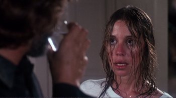 Movie still from “A Star Is Born” (1976), directed by Frank Pierson – A woman crying in front of a mirror with a glass; Close Up shot, Over the shoulder angle