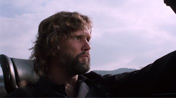 Movie still from “A Star Is Born” (1976), directed by Frank Pierson – A person with a beard looking to the side; Close Up shot, Low angle