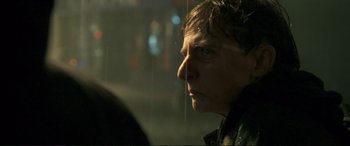 Movie still from “A Street Cat Named Bob” (2016), directed by Roger Spottiswoode – A man with wet hair looking out of a window; Close Up shot, Over the shoulder angle