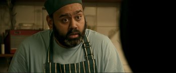 Movie still from “A Street Cat Named Bob” (2016), directed by Roger Spottiswoode – A person wearing an apron; Close Up shot, Over the shoulder angle