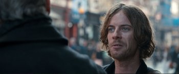 Movie still from “A Street Cat Named Bob” (2016), directed by Roger Spottiswoode – A person with long hair and blue eyes; Close Up shot, Over the shoulder angle