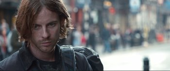 Movie still from “A Street Cat Named Bob” (2016), directed by Roger Spottiswoode – A person with long hair; Close Up shot, Over the shoulder angle