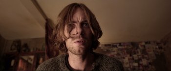 Movie still from “A Street Cat Named Bob” (2016), directed by Roger Spottiswoode – A person with long brown hair; Close Up shot, Low angle