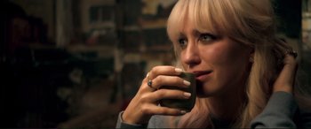Movie still from “A Street Cat Named Bob” (2016), directed by Roger Spottiswoode – A woman drinking a cup of coffee from a green mug; Close Up shot, Over the shoulder angle