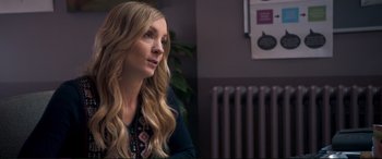 Movie still from “A Street Cat Named Bob” (2016), directed by Roger Spottiswoode – A woman with long blonde hair sitting in front of a radiator; Close Up shot, Over the shoulder angle
