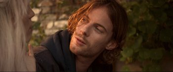 Movie still from “A Street Cat Named Bob” (2016), directed by Roger Spottiswoode – A person with long brown hair; Close Up shot, Low angle