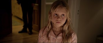 Movie still from “A Street Cat Named Bob” (2016), directed by Roger Spottiswoode – A young girl in a pink shirt is looking at the camera; Close Up shot, High angle