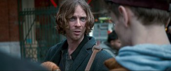 Movie still from “A Street Cat Named Bob” (2016), directed by Roger Spottiswoode – A person wearing a jacket; Close Up shot, Over the shoulder angle