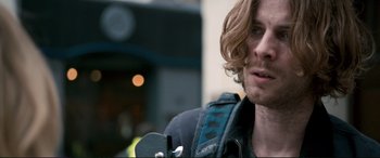 Movie still from “A Street Cat Named Bob” (2016), directed by Roger Spottiswoode – A person holding a camera; Close Up shot, Over the shoulder angle