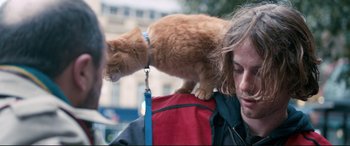 Movie still from “A Street Cat Named Bob” (2016), directed by Roger Spottiswoode – An orange cat standing on the shoulder of a person; Close Up shot, Over the shoulder angle