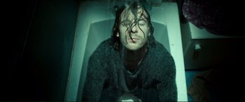 Movie still from “A Street Cat Named Bob” (2016), directed by Roger Spottiswoode – A man with wet hair is taking a bath; Medium shot, Overhead angle